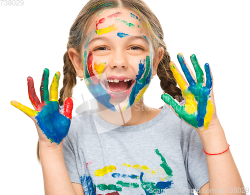 Image of Portrait of a cute girl playing with paints