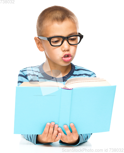 Image of Little boy is reading a book