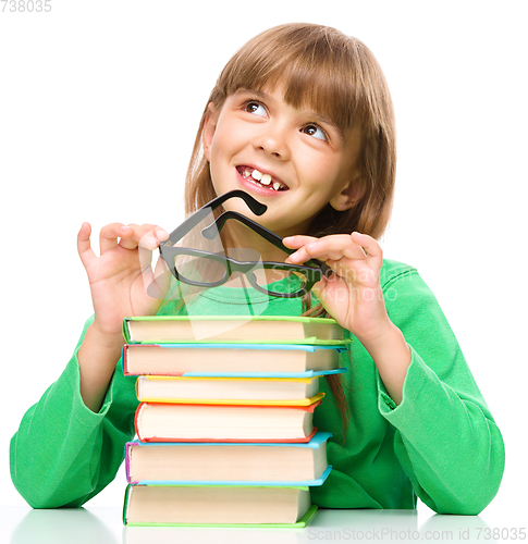 Image of Little girl is reading a book