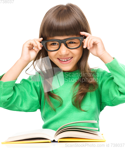 Image of Little girl is reading a book