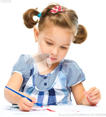 Image of Little girl is painting with gouache