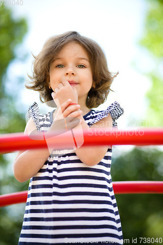 Image of Cute little girl is playing in playground