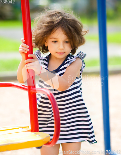 Image of Young girl is playing in playground