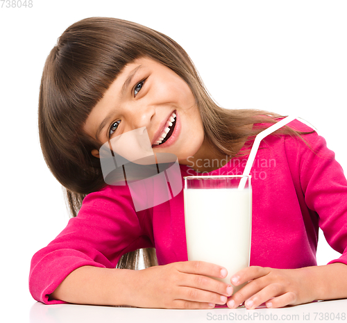 Image of Cute little girl with a glass of milk