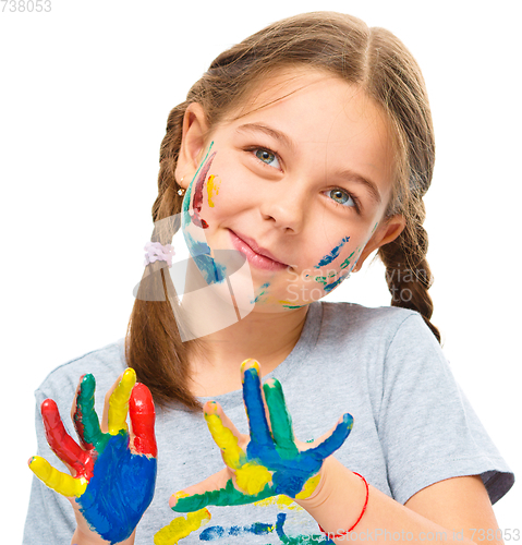 Image of Portrait of a cute girl playing with paints