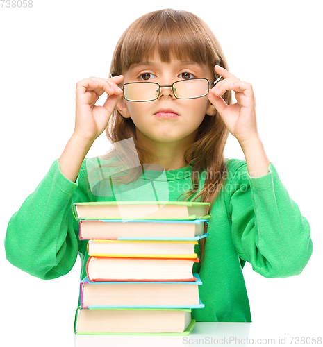 Image of Little girl is reading a book