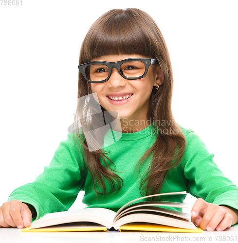 Image of Little girl is reading a book