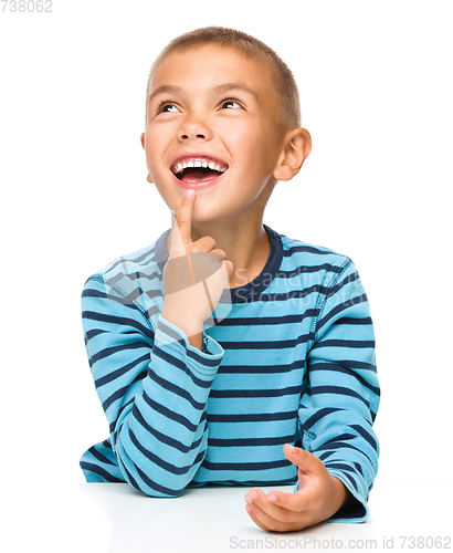 Image of Young boy is daydreaming