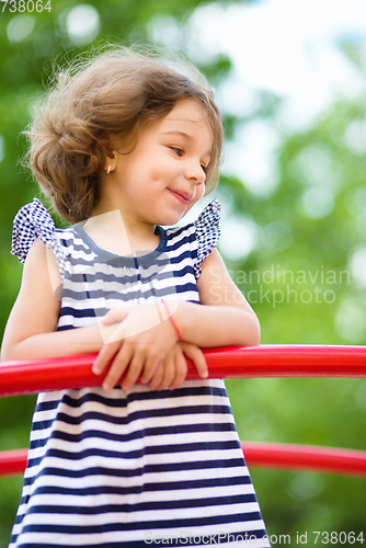 Image of Cute little girl is playing in playground