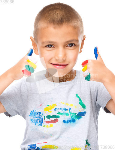 Image of Portrait of a cute boy playing with paints