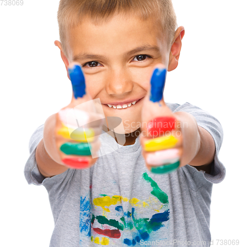 Image of Portrait of a cute boy playing with paints