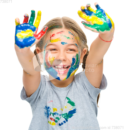 Image of Portrait of a cute girl playing with paints