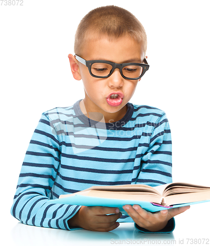 Image of Little boy is reading a book