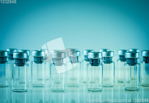 Image of Vaccine glass bottles on blue background