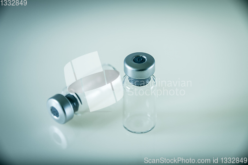 Image of two vaccine bottles on grey background