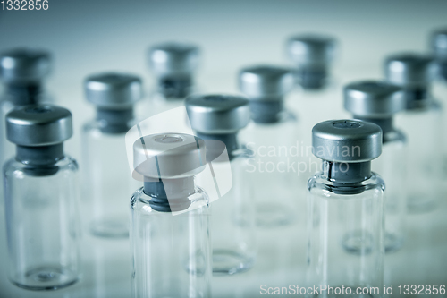 Image of Vaccine glass bottles on grey background