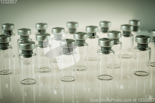 Image of Vaccine glass bottles on grey background