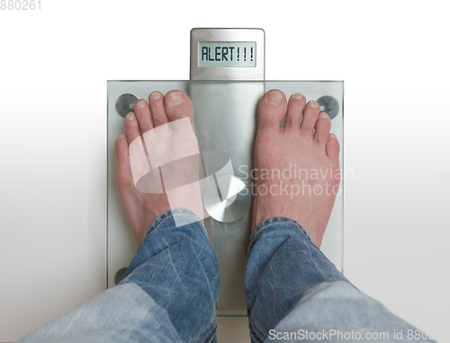 Image of Man\'s feet on weight scale - Alert