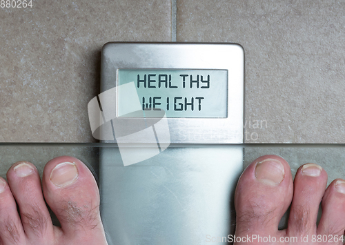 Image of Man\'s feet on weight scale - Healthy weight