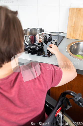 Image of disabled woman cooking in the kitchen