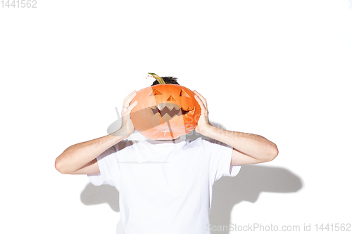 Image of Young man holding pumpking on white background