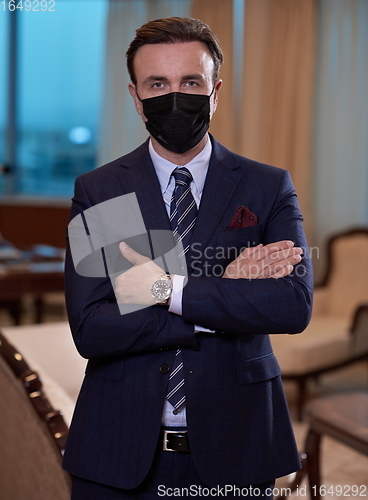 Image of business man wearing protective face mask at office