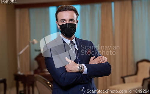 Image of business man wearing protective face mask at office