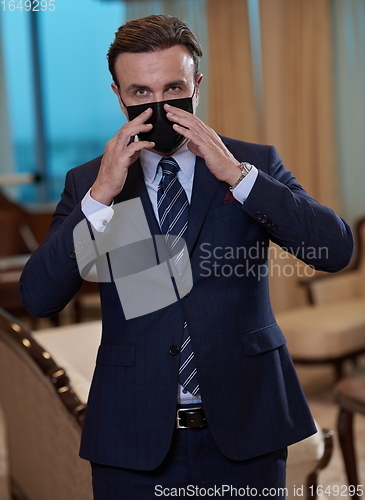 Image of business man wearing protective face mask at office