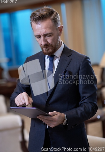 Image of business man using tablet computer