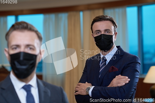 Image of business team wearing crona virus protection face mask