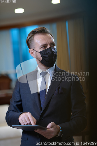 Image of business man wearing protective face mask at office