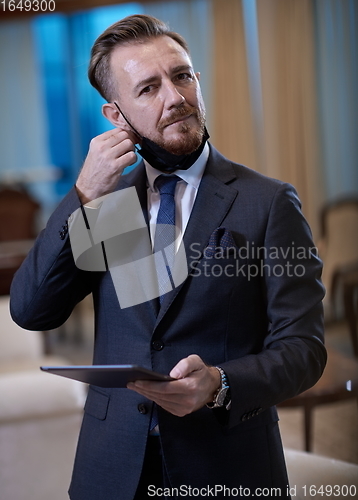 Image of business man wearing protective face mask at office