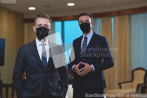 Image of business team wearing crona virus protection face mask