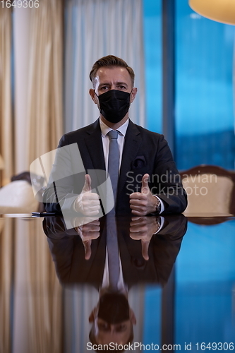 Image of business man wearing protective face mask at luxury office