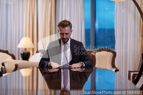 Image of business man using tablet computer