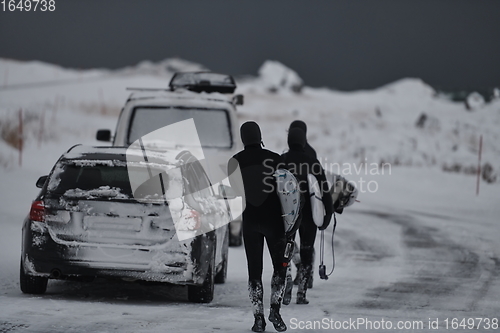 Image of Arctic surfers in wetsuit after surfing by minivan
