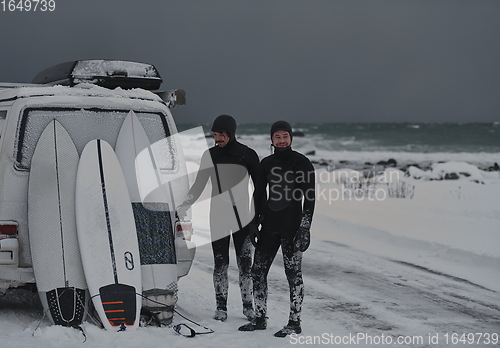 Image of Arctic surfers in wetsuit after surfing by minivan