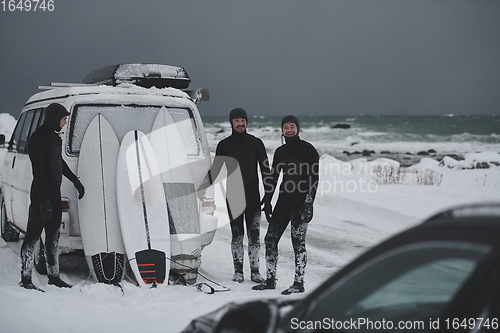 Image of Arctic surfers in wetsuit after surfing by minivan