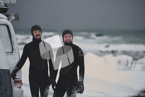 Image of Arctic surfers in wetsuit after surfing by minivan