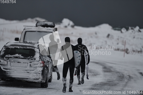 Image of Arctic surfers in wetsuit after surfing by minivan