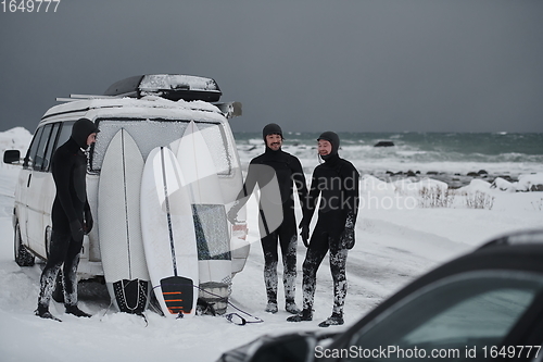 Image of Arctic surfers in wetsuit after surfing by minivan