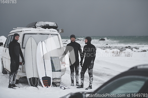 Image of Arctic surfers in wetsuit after surfing by minivan