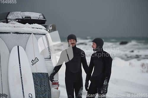 Image of Arctic surfers in wetsuit after surfing by minivan