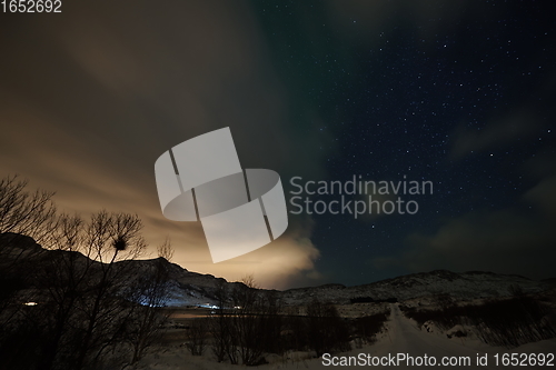 Image of Aurora borealis Green northern lights above mountains