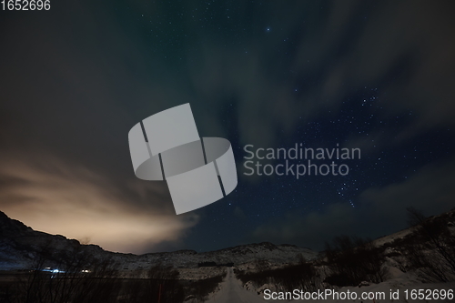 Image of Aurora borealis Green northern lights above mountains