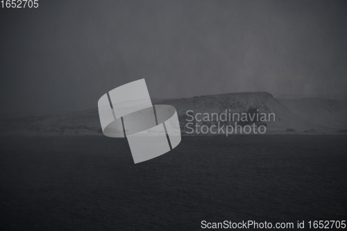 Image of norway coast in winter with snow bad cloudy weather