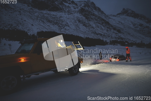 Image of Car being towed after accident in snow storm