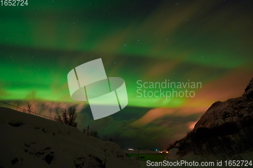 Image of Aurora borealis Green northern lights above mountains