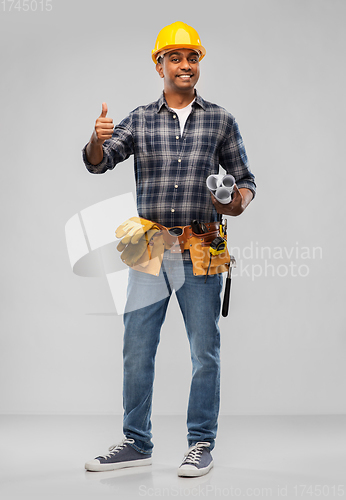 Image of happy indian builder with blueprint and clipboard