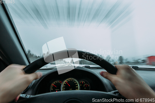 Image of Riding behind the wheel of a car in winter